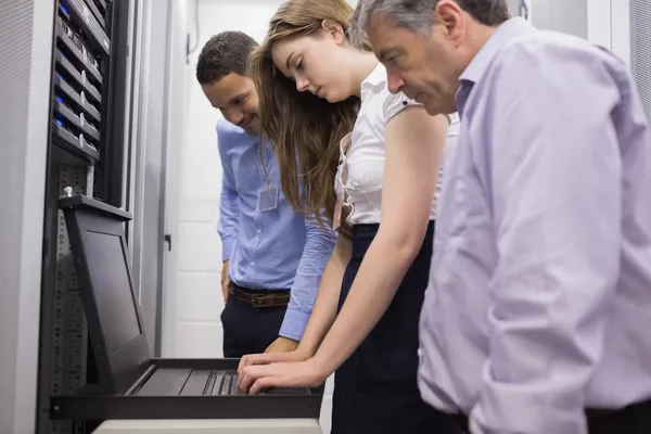 Drie technici kijken naar laptop — Stockfoto