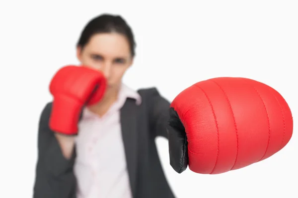 Serious brunette wearing red gloves punching — Stock Photo, Image