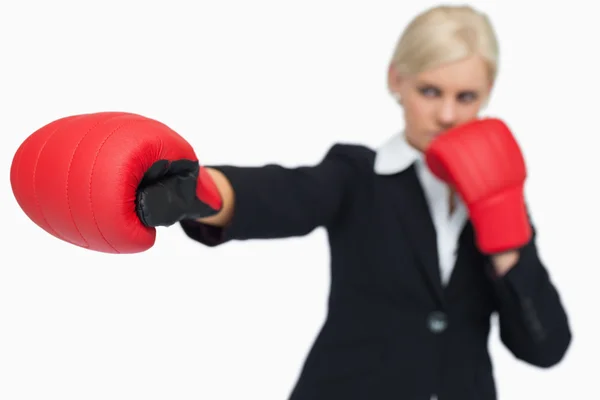 Blonde businesswoman with red gloves boxing — Stock Photo, Image