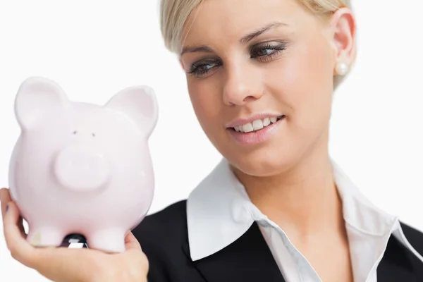 Cute businesswoman holding a piggy-bank — Stock Photo, Image