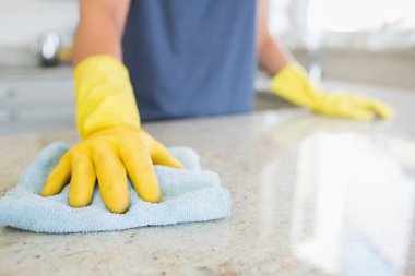 Woman cleaning the counter clipart