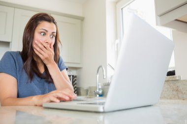 Woman shocked at laptop clipart