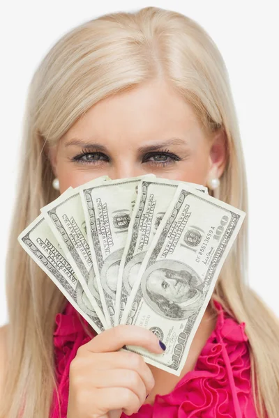 Blonde hiding her face with dollars banknotes — Stock Photo, Image