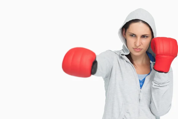 Brunette woman in sweatshirt boxing — Stock Photo, Image