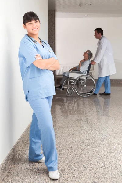 Proud nurse standing in the hallway — Stock Photo, Image