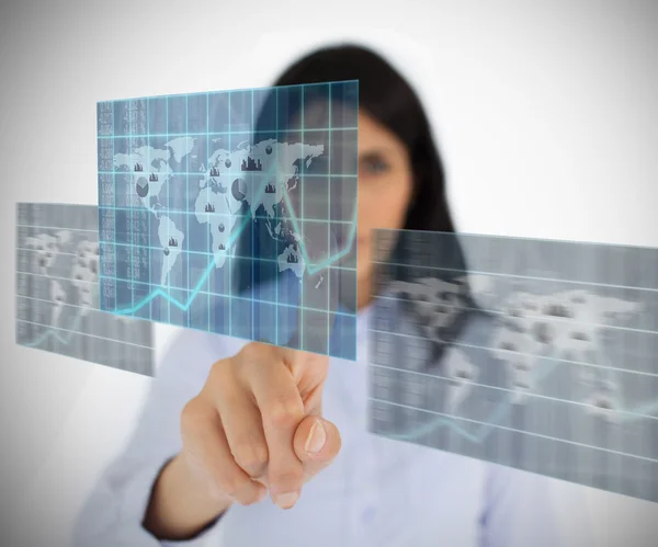 Woman selecting world map image from hologram interface — Stock Photo, Image