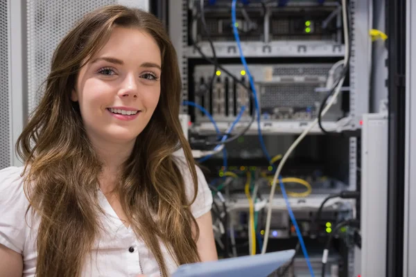 Smiling woman standing in front of servers — Stock Photo, Image