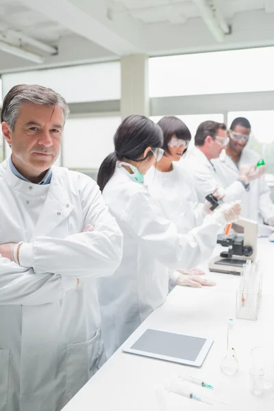 Chemist standing in front of tablet pc — Stock Photo, Image