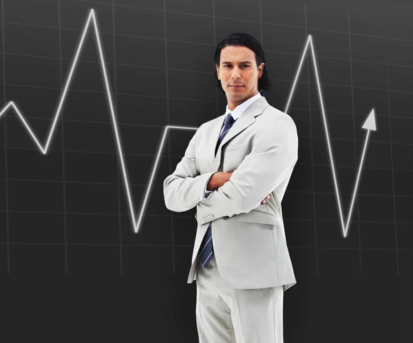 Man with arms crossed standing in front of a statistic — Stock Photo, Image