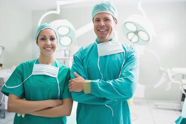 Smiling surgeons looking at camera — Stock Photo, Image