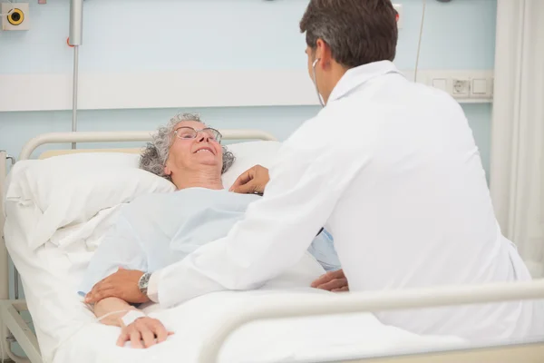 Doctor caring about elderly lady — Stock Photo, Image