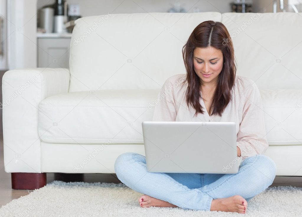 Woman sitting on the carpet with her laptop Stock Photo by ...