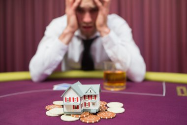 Man is betting his house at poker game clipart