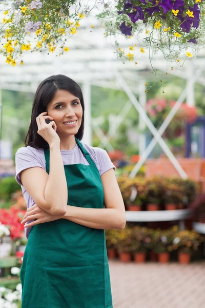 Blumenhändler telefoniert lächelnd — Stockfoto