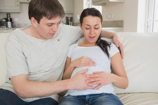 Baby kicking in mother's stomach — Stock Photo, Image