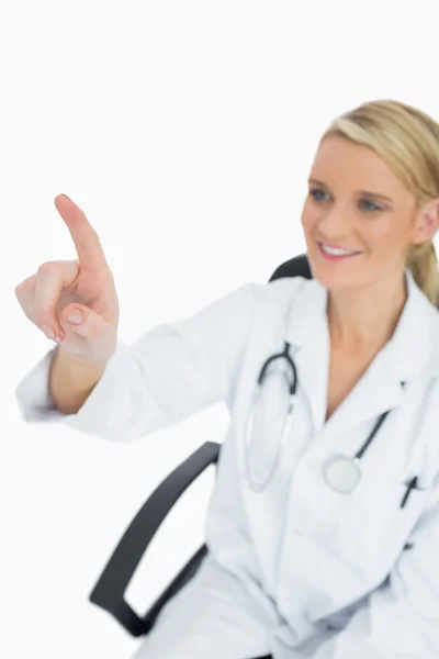 Cheerful doctor touching on something — Stock Photo, Image