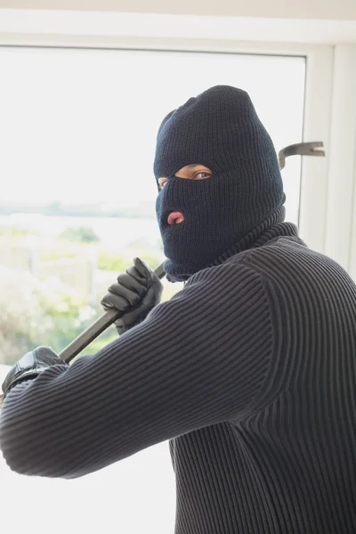 Robber holding a crowbar in his hands — Stock Photo, Image