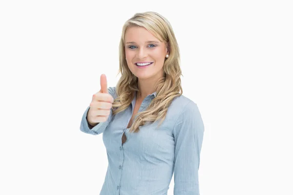 Mujer sonriendo mientras muestra los pulgares hacia arriba — Foto de Stock