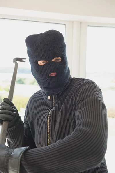 Robber holding a crowbar — Stock Photo, Image