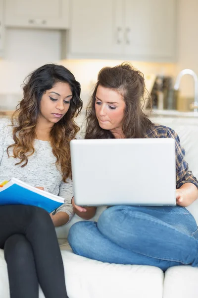 Girls doing homework with laptop — Stock Photo, Image