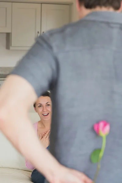 Man hiding flower behind his back for wife — Stock Photo, Image