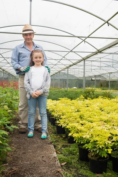 Gardener with granddaughter in greenhouse — Stock Photo, Image