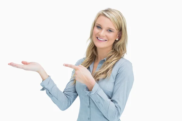 Woman pointing at her hand — Stock Photo, Image