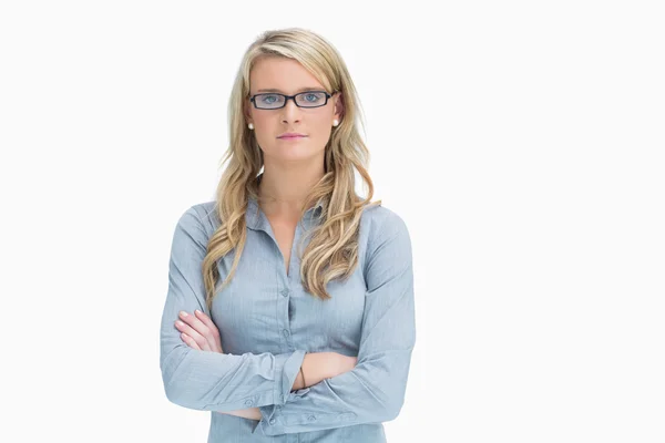 Woman wearing glasses while crossing arms — Stock Photo, Image