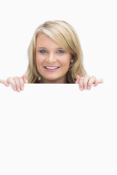 Woman looking above the poster — Stock Photo, Image