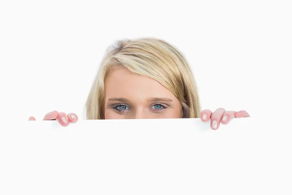 Woman hiding behind a notice — Stock Photo, Image