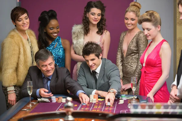 Mannen spelen roulette als vrouwen in de gaten — Stockfoto