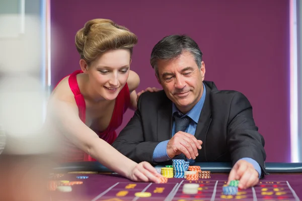 Man and woman placing bets — Stock Photo, Image