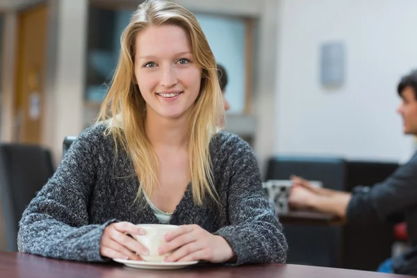 Femme assise à boire une tasse de café — Photo