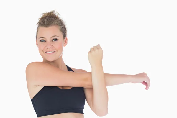 Woman standing while stretching arms — Stock Photo, Image