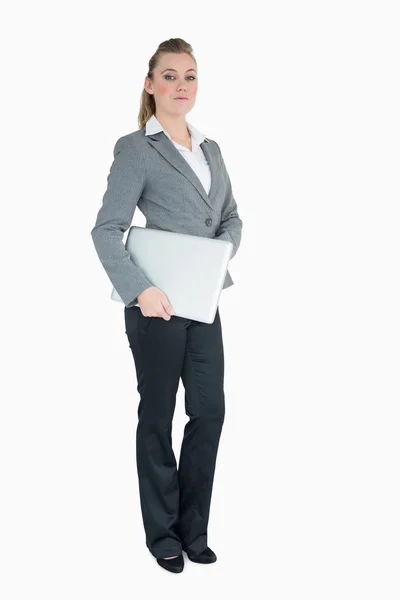 Serious businesswoman holding laptop — Stock Photo, Image