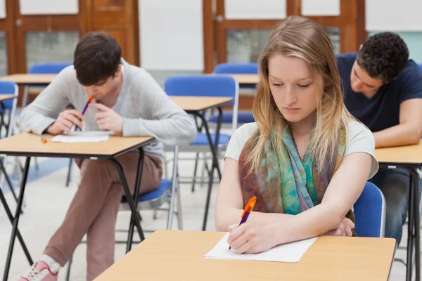 Female student sitting at table Stock Picture
