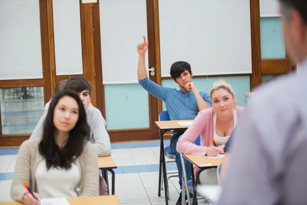 Student raising hand to ask question — Stock Photo, Image