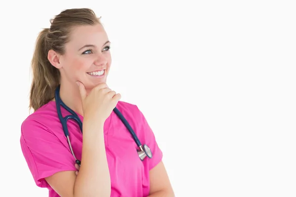 Smiling doctor looking thoughtful — Stock Photo, Image