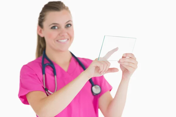 Female doctor touching glass slide — Stock Photo, Image