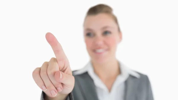Smiling woman pointing in the air — Stock Photo, Image