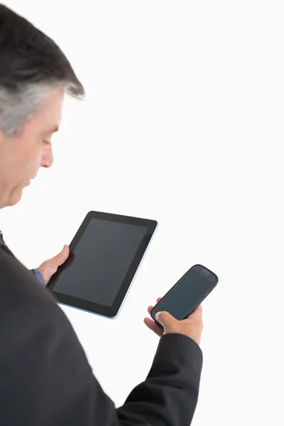 Businessman holding tablet pc and mobile phone — Stock Photo, Image