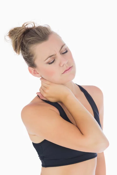 Woman holding hand to stiff neck — Stock Photo, Image