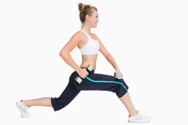 Woman stretching while holding weights — Stock Photo, Image