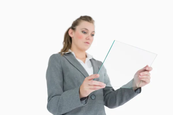 Blonde businesswoman viewing glass pane — Stock Photo, Image