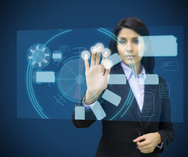 Concentrate woman touching a hologram — Stock Photo, Image