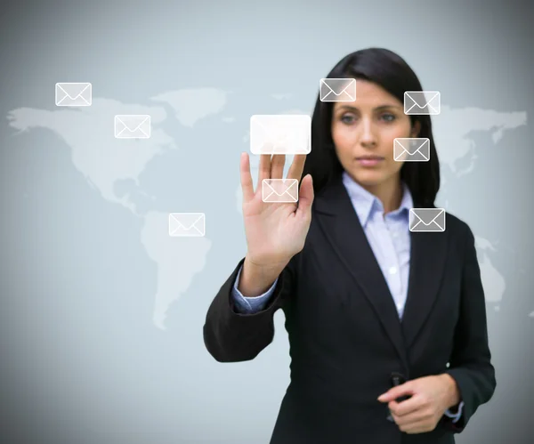 Businesswoman pushing email symbol — Stock Photo, Image