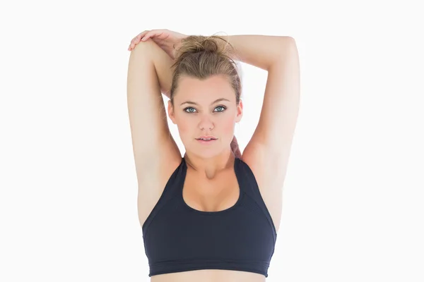 Woman standing stretching her arms — Stock Photo, Image