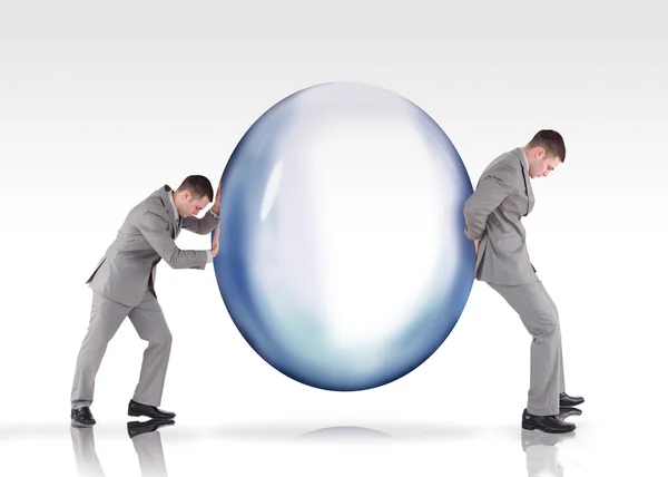 Businessmen pushing a bubble — Stock Photo, Image