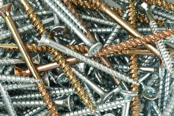 Parafusos e pregos de cobre e prata — Fotografia de Stock