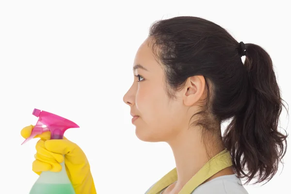 Woman spraying cleaning product — Stock Photo, Image